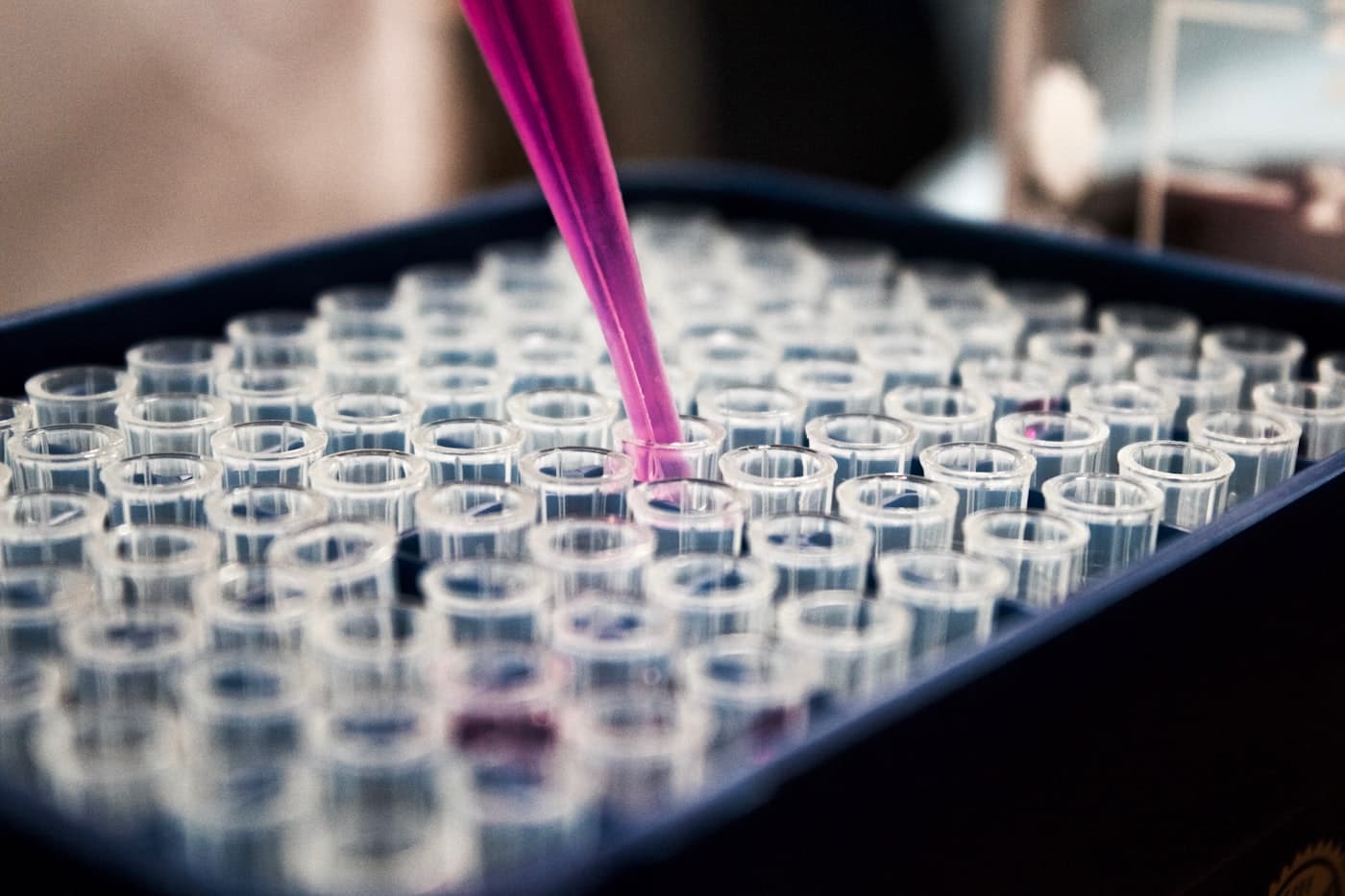 Lab technician pouring liquid into a flask during scientific work